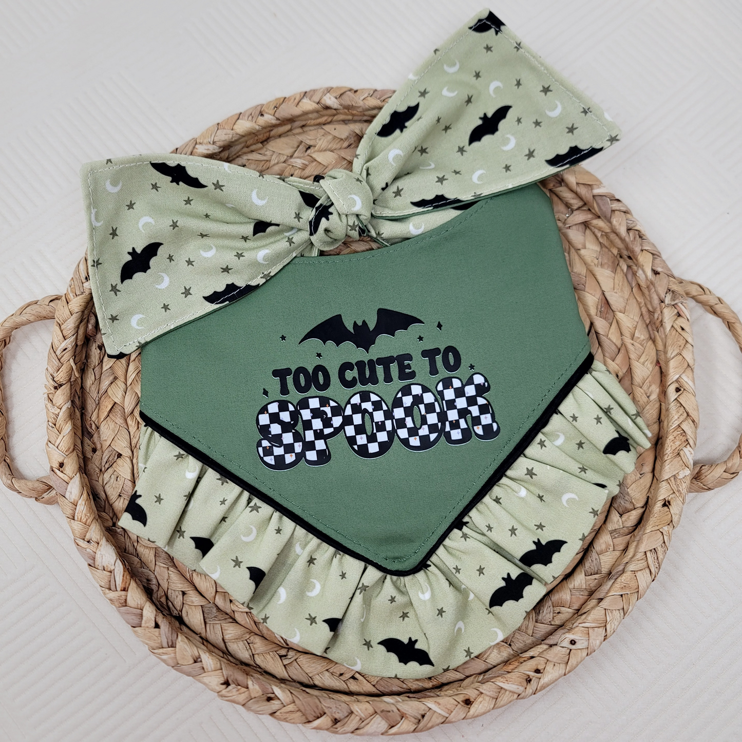 Green dog bandana with "Too Cute To Spook" text and ruffle trim with black bats.