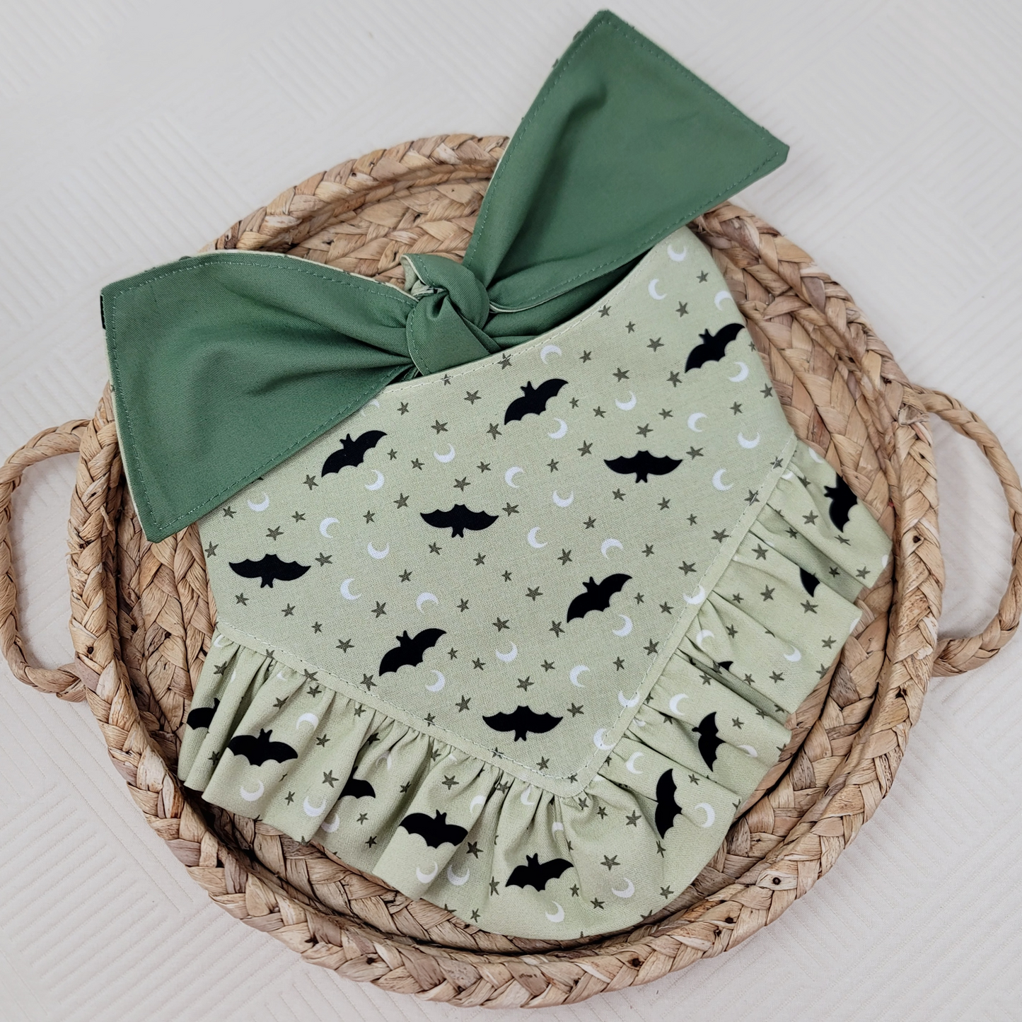 Green dog bandana with "Too Cute To Spook" text and ruffle trim with black bats.