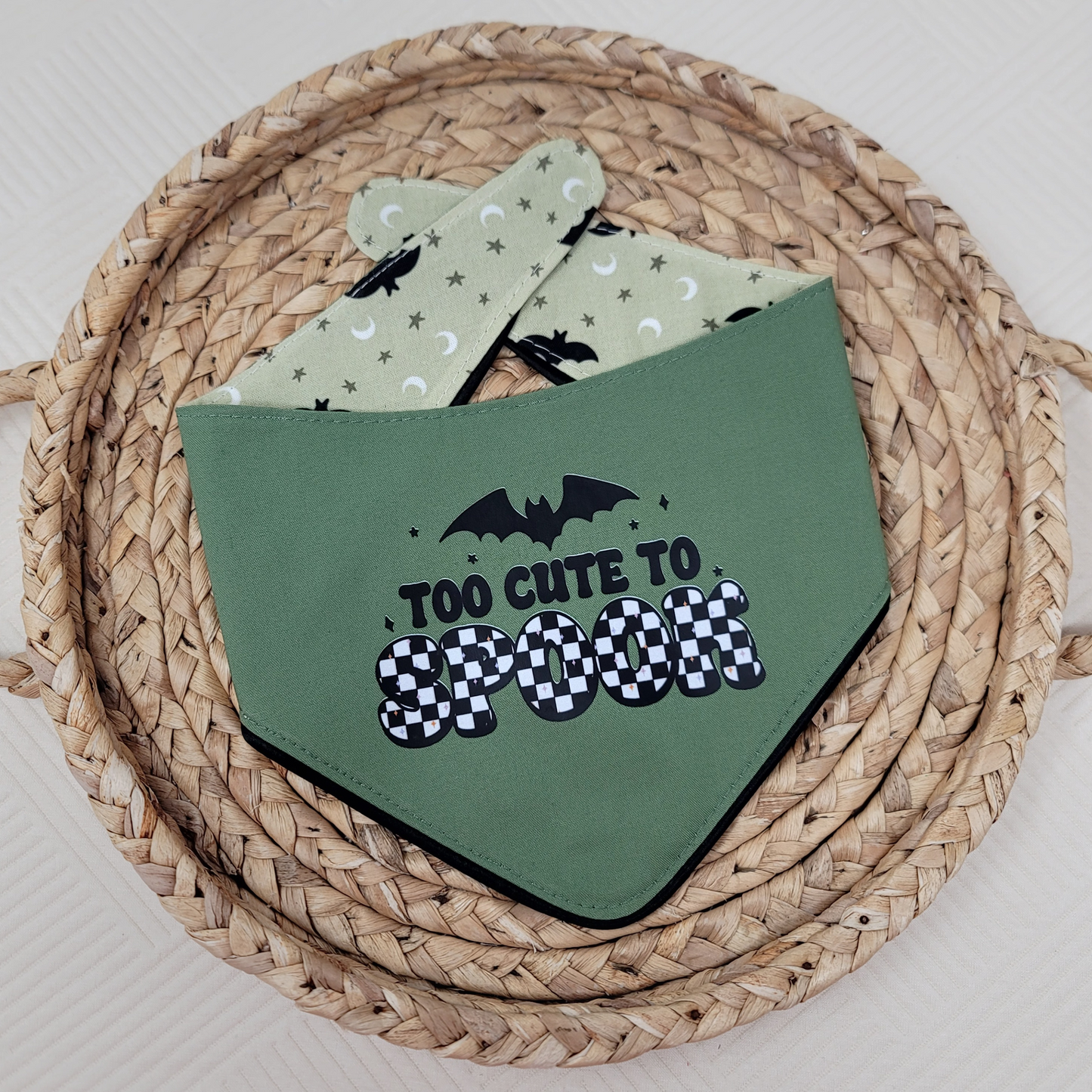 Green dog bandana with "Too Cute To Spook" text and ruffle trim with black bats.