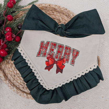 Christmas-themed dog bandana with 'MERRY' and a bow on a woven mat.